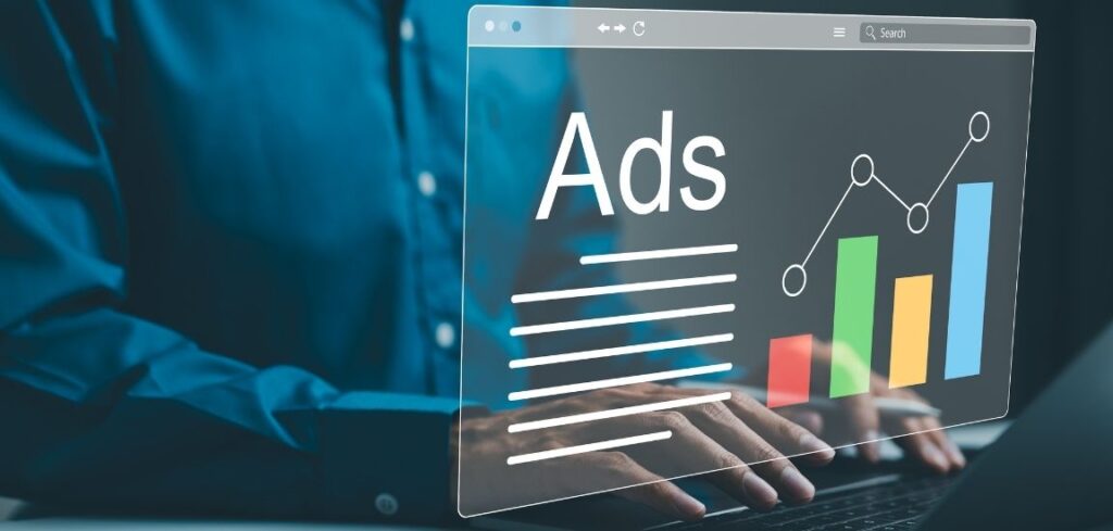 Person typing on a laptop with a transparent digital dashboard displaying Ads a bar chart, and a trend line representing online advertising analytics and campaign growth
